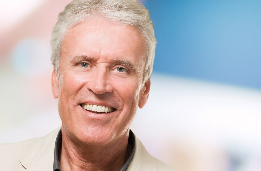 Smiling middle-aged man with white hair