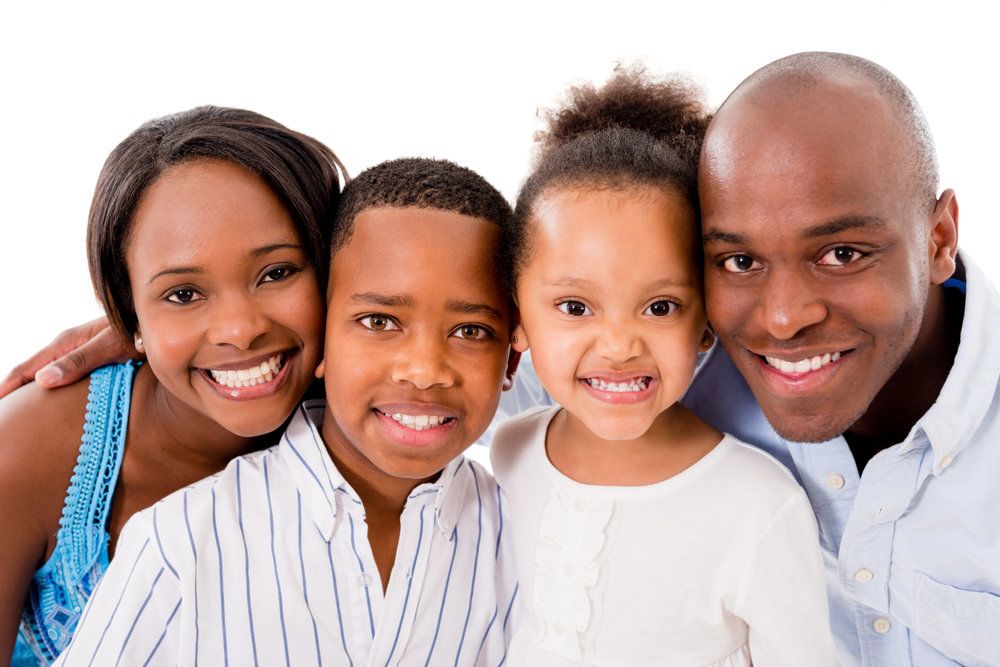 Smiling mother and father with two children