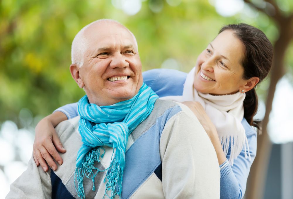 Laughing couple wearing bright scarves